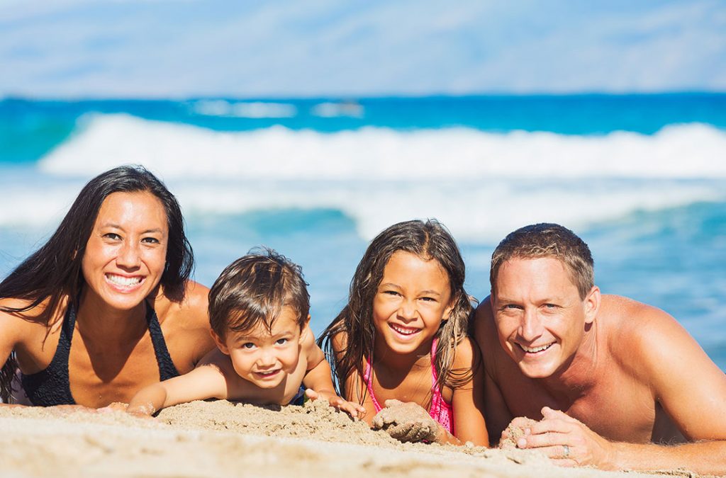 Hawaii family smiling at the beach.